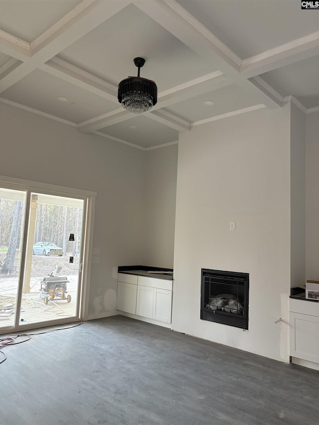 unfurnished living room featuring coffered ceiling, heating unit, an inviting chandelier, beamed ceiling, and concrete floors