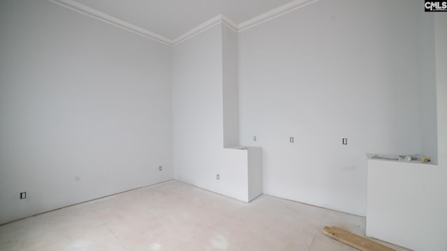 unfurnished room with crown molding