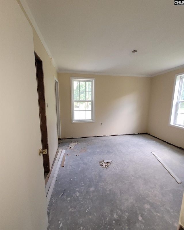 unfurnished room featuring crown molding