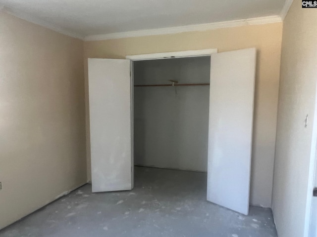 unfurnished bedroom featuring a closet and ornamental molding