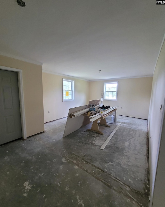 unfurnished living room featuring crown molding