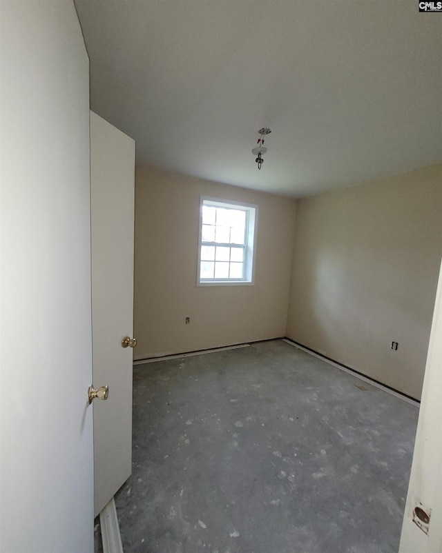 spare room featuring unfinished concrete floors