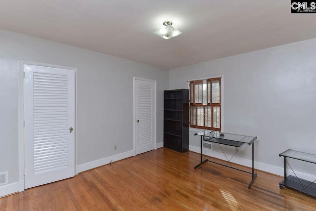 spare room with light hardwood / wood-style flooring