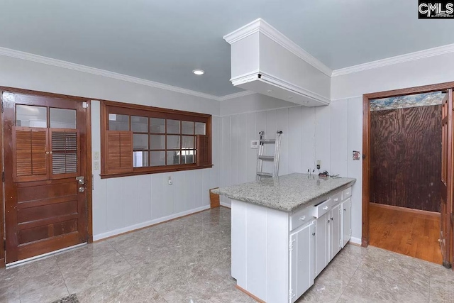 kitchen featuring light tile flooring, white cabinetry, and crown molding