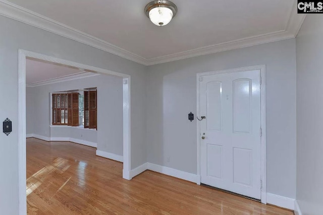 foyer with light wood-type flooring and ornamental molding