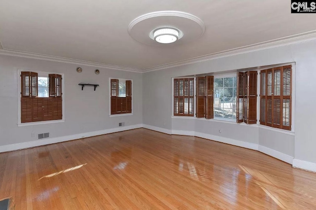 unfurnished room with light hardwood / wood-style floors and crown molding