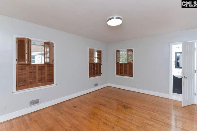 spare room with a healthy amount of sunlight and light wood-type flooring