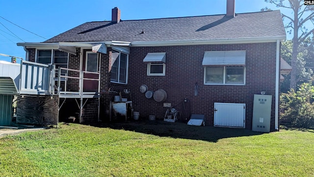 back of house with a deck and a yard