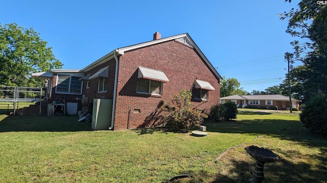 view of side of property with a lawn