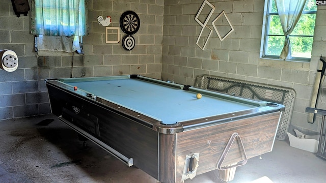 playroom with tile walls, concrete floors, and pool table