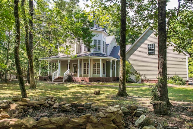 view of front of home with covered porch and a front yard