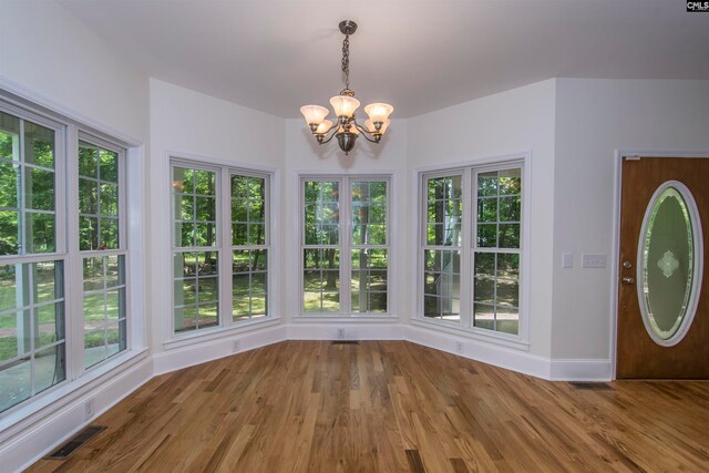 interior space featuring hardwood / wood-style flooring and a chandelier