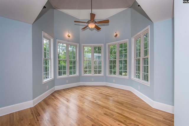 unfurnished sunroom with ceiling fan