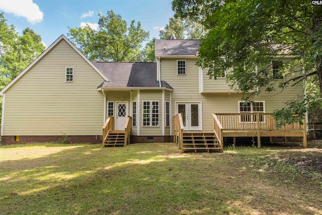 rear view of house featuring a deck, a yard, and french doors