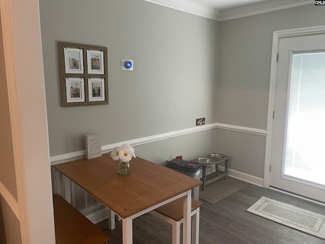 dining space featuring ornamental molding and dark hardwood / wood-style floors