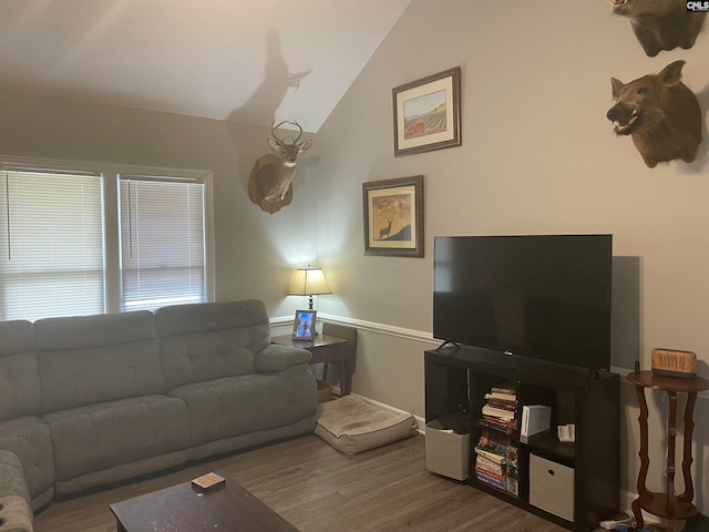 living room with lofted ceiling and hardwood / wood-style flooring