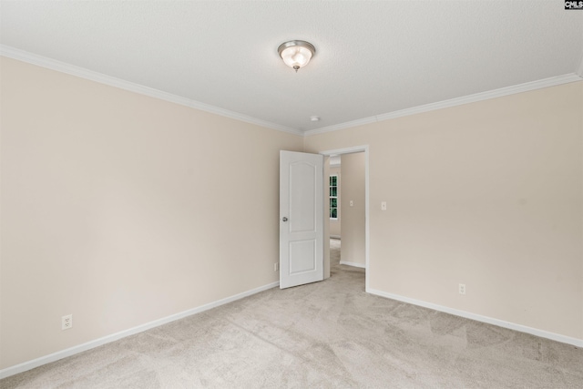 carpeted empty room featuring crown molding