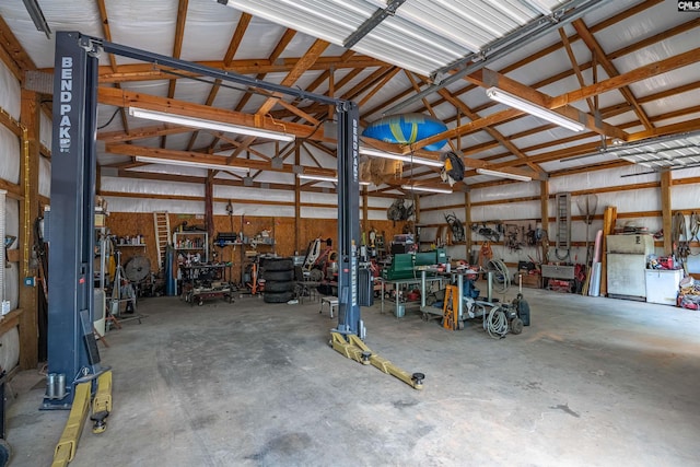 garage with metal wall and a workshop area