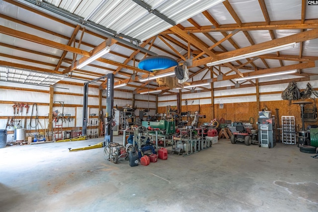 garage featuring metal wall and a workshop area