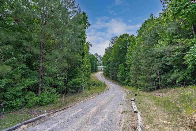 view of street featuring a forest view