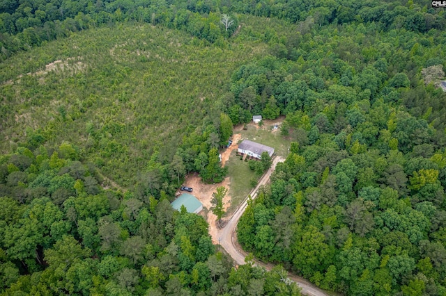 birds eye view of property featuring a view of trees