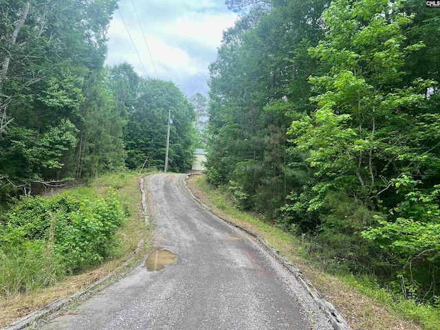 view of street featuring a forest view