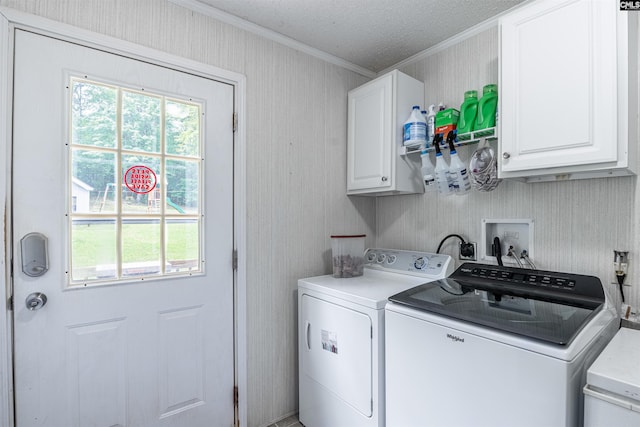 washroom featuring ornamental molding, independent washer and dryer, a textured ceiling, and cabinets