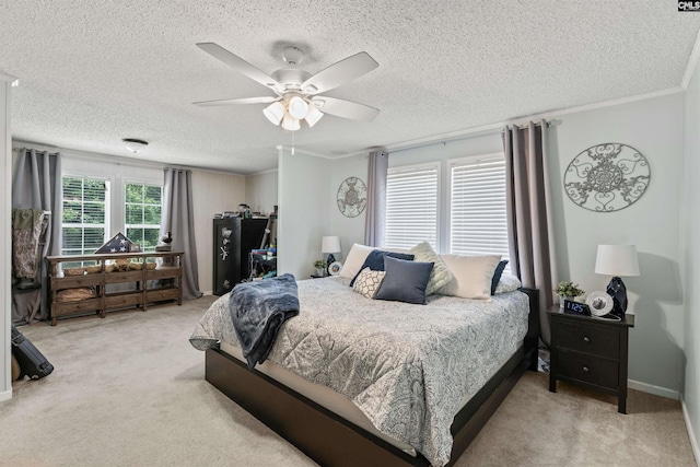 bedroom with ornamental molding, light carpet, ceiling fan, and a textured ceiling