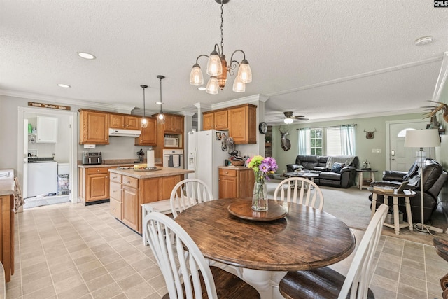 dining area with recessed lighting, washer / clothes dryer, ornamental molding, a textured ceiling, and ceiling fan with notable chandelier