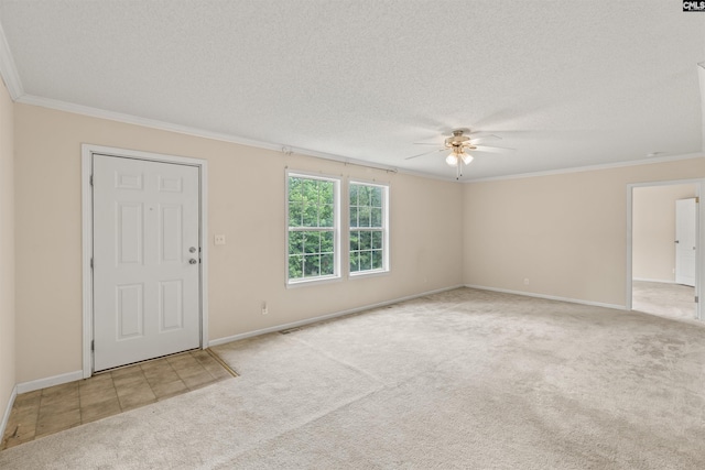 foyer with a textured ceiling, ceiling fan, ornamental molding, and light carpet