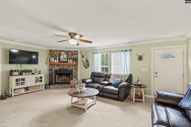 carpeted living area with ceiling fan, a textured ceiling, a stone fireplace, baseboards, and ornamental molding