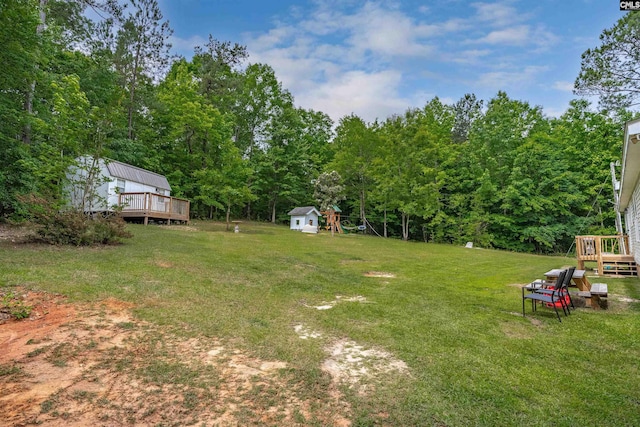 view of yard with an outbuilding, a storage shed, and a wooden deck