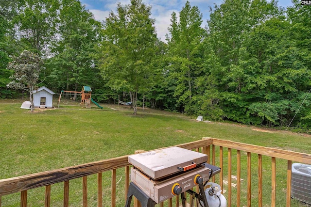 view of yard featuring central AC unit and a playground