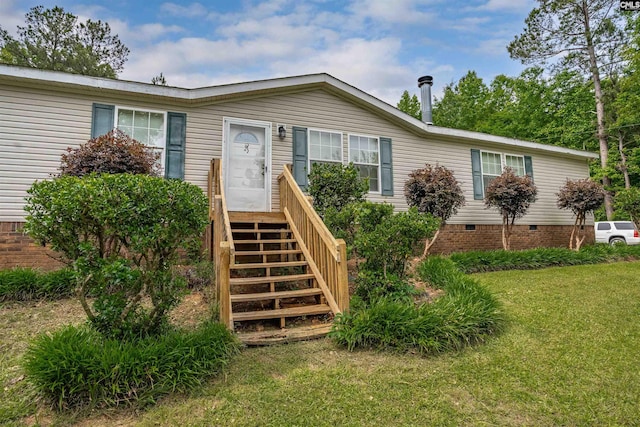 view of front facade featuring stairway, crawl space, and a front yard