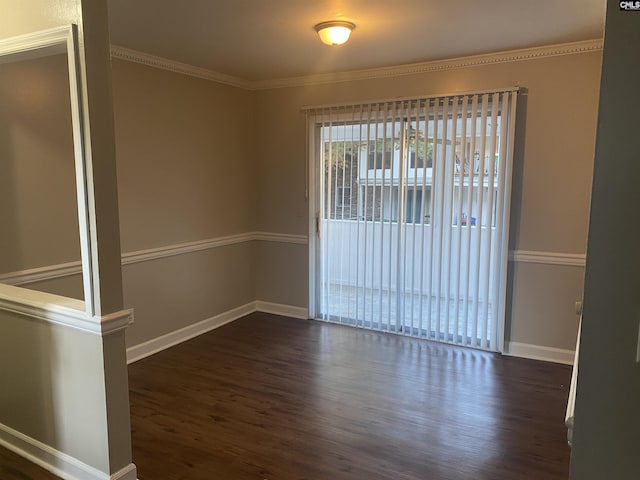 unfurnished room featuring ornamental molding, dark wood-style flooring, and baseboards