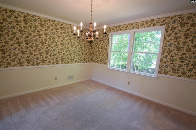 unfurnished room featuring crown molding, carpet flooring, and a chandelier