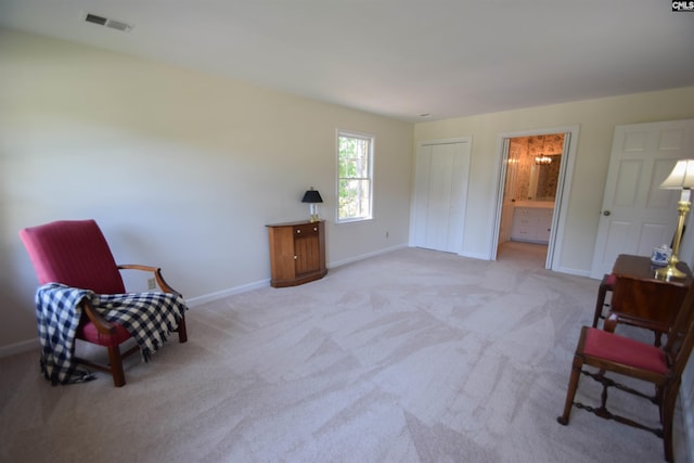 sitting room featuring light carpet