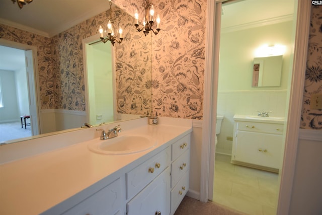 bathroom with tile patterned flooring, vanity, ornamental molding, and toilet