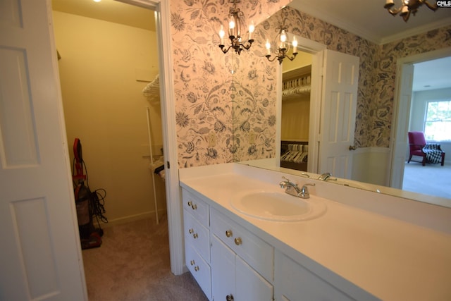 bathroom featuring vanity, a chandelier, and crown molding