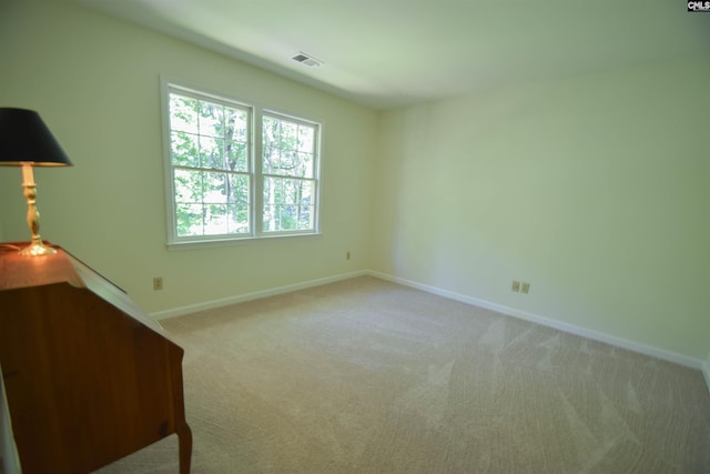 spare room featuring light colored carpet