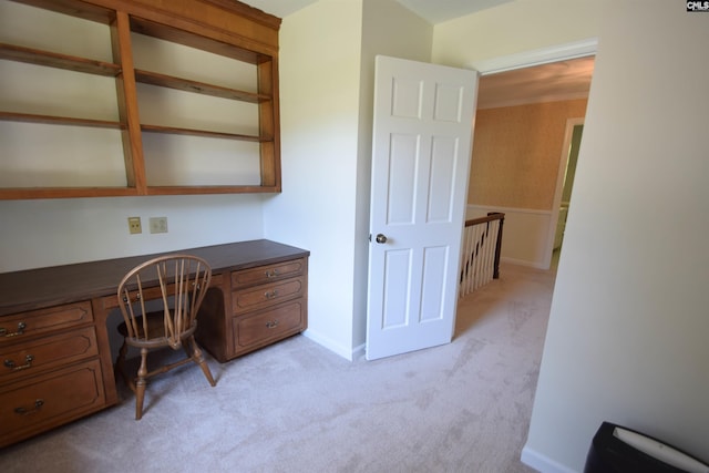 carpeted home office with built in desk