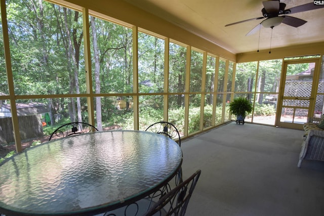 unfurnished sunroom featuring ceiling fan