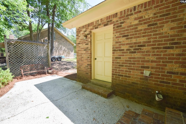 entrance to property featuring a patio area