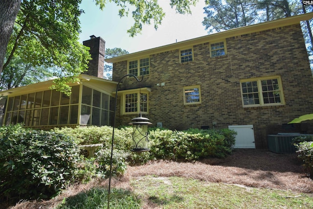 back of property with a sunroom