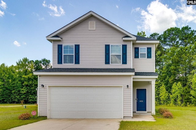 view of front of property featuring a front yard and a garage