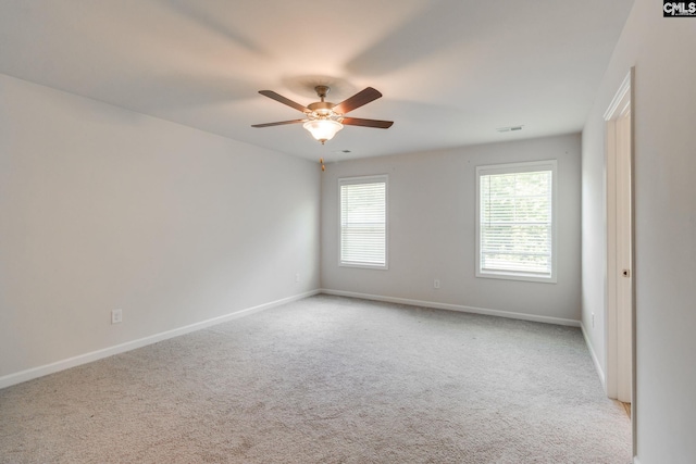 empty room with ceiling fan and light colored carpet