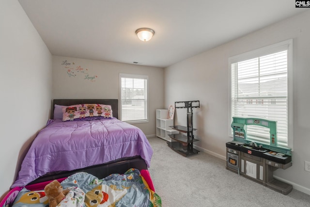 carpeted bedroom with multiple windows