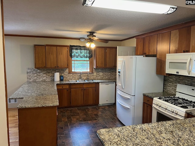 kitchen featuring ceiling fan, sink, a textured ceiling, white appliances, and ornamental molding