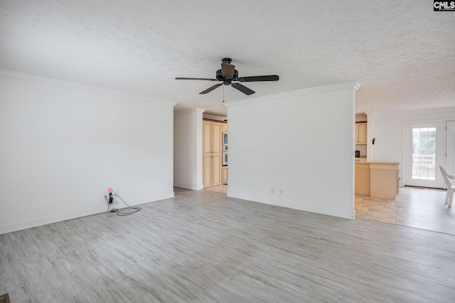 empty room featuring light hardwood / wood-style floors, a textured ceiling, ornamental molding, and ceiling fan