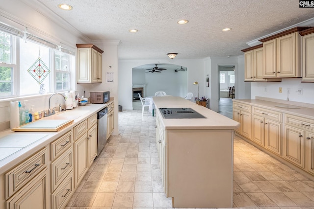 kitchen featuring a kitchen island, ceiling fan, light tile floors, black appliances, and a textured ceiling